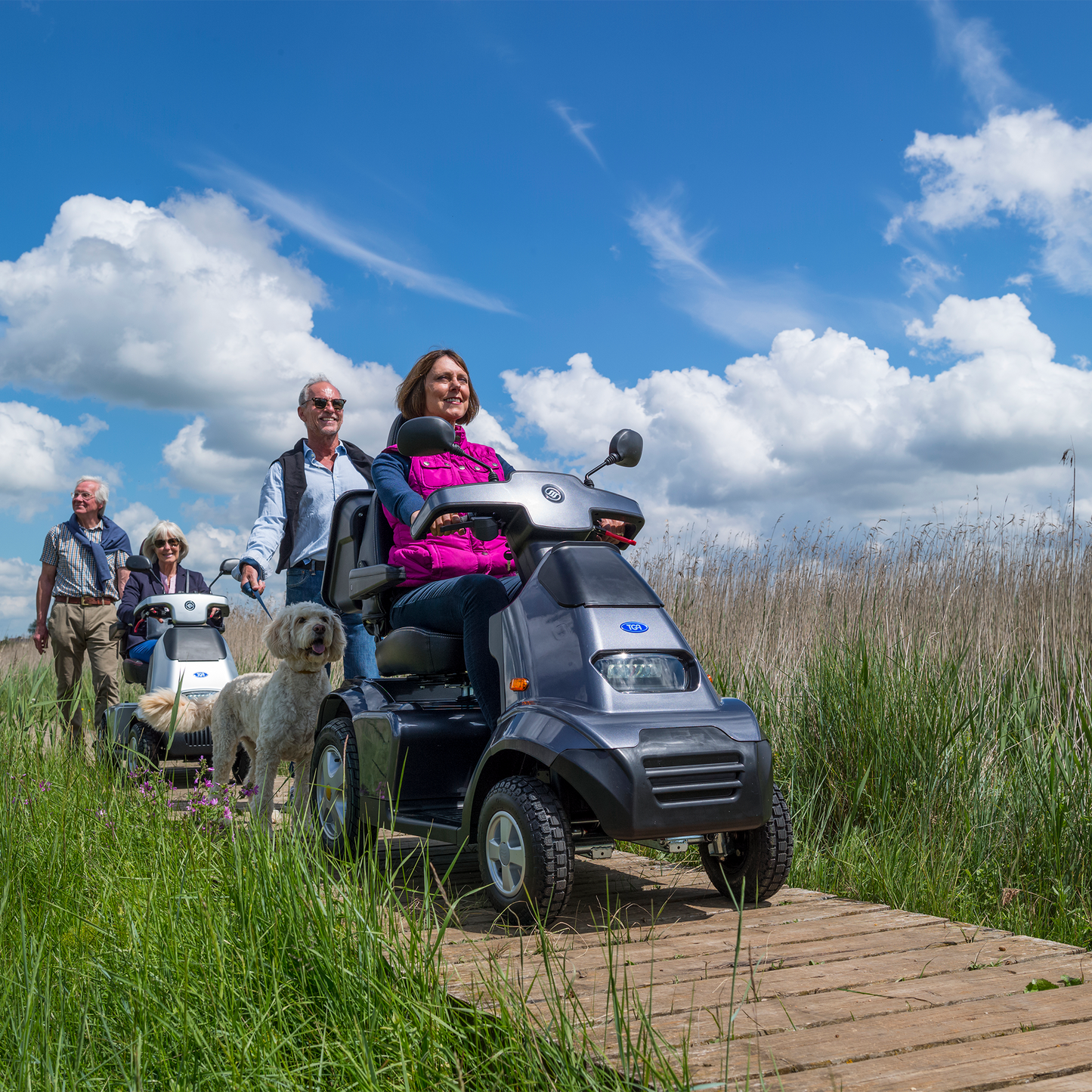 Showing a lady Driving the Breeze S4 across a Wooden Walkway along the beach.